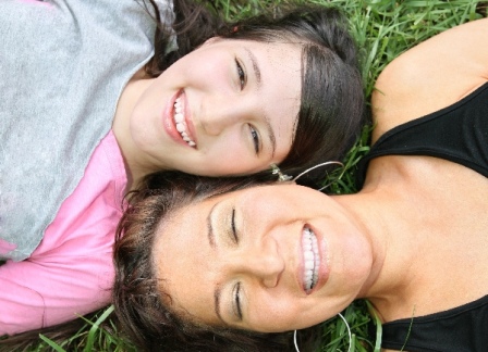 smiley mom and daughter on grass