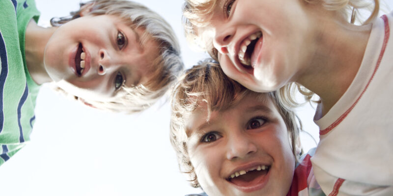 Boys huddling, smiling down at camera