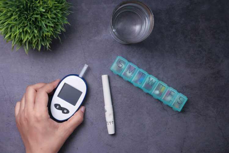Women hand measuring diabetic glucose level at home .